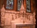 The first mass on the altar of the Lady Chapel was said on Christmas Eve by Bishop Thomas Starkey in 1895.  The Altar is built of white statuary and blue veined white marble and contrary to current popular belief it was not moved from the old church but was built for its present location as a memorial to Mr. Fiskes wife's, Marionne, parents Sarah Cowles Cushman (the altar) and Archibald Falconer Cushman (altar statuary).  